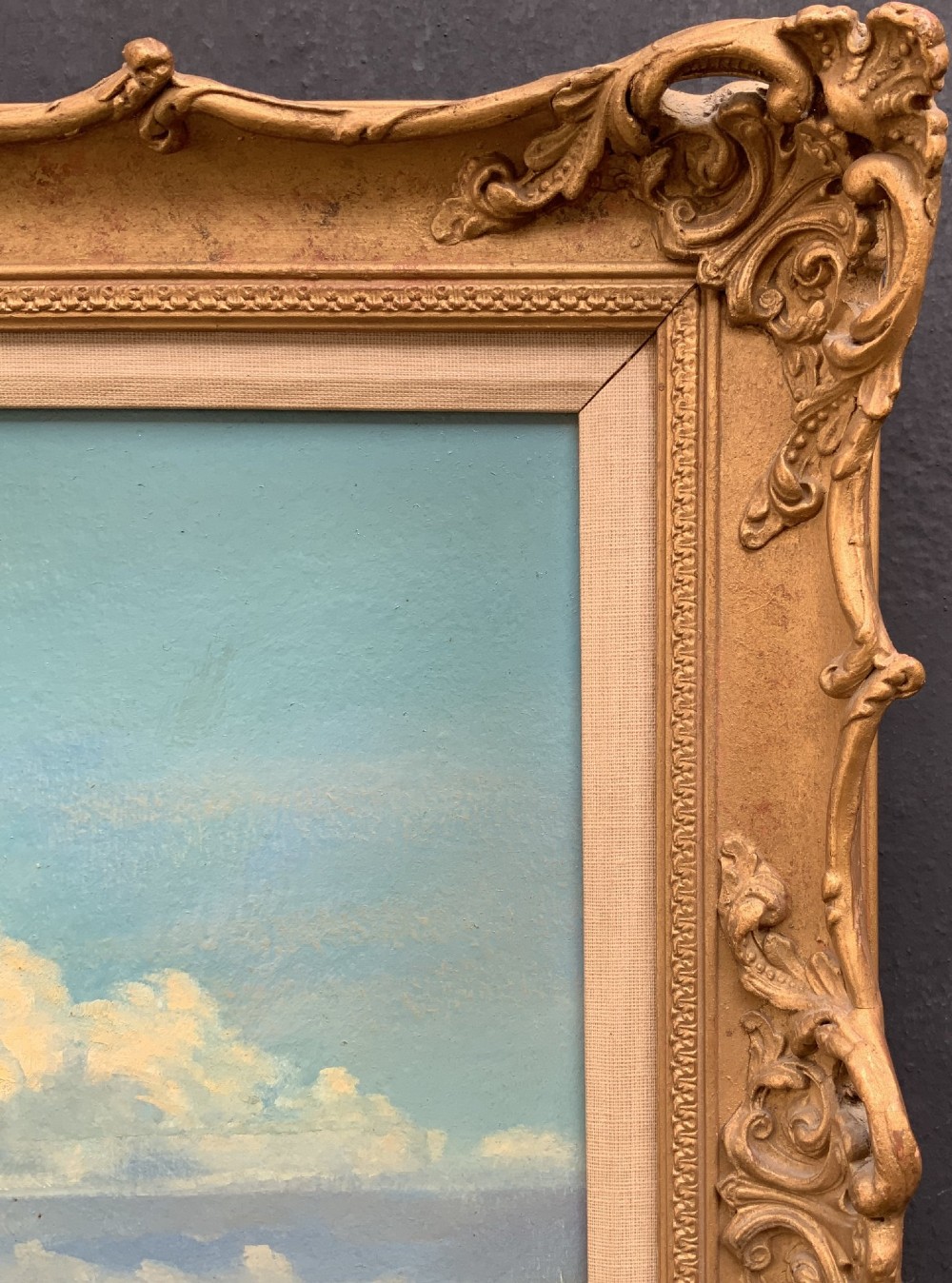 An oil painting depicting Horsey Mill set amidst the Norfolk Broads under a cloud-filled sky, presented in an elaborate gilded swept frame. View X
