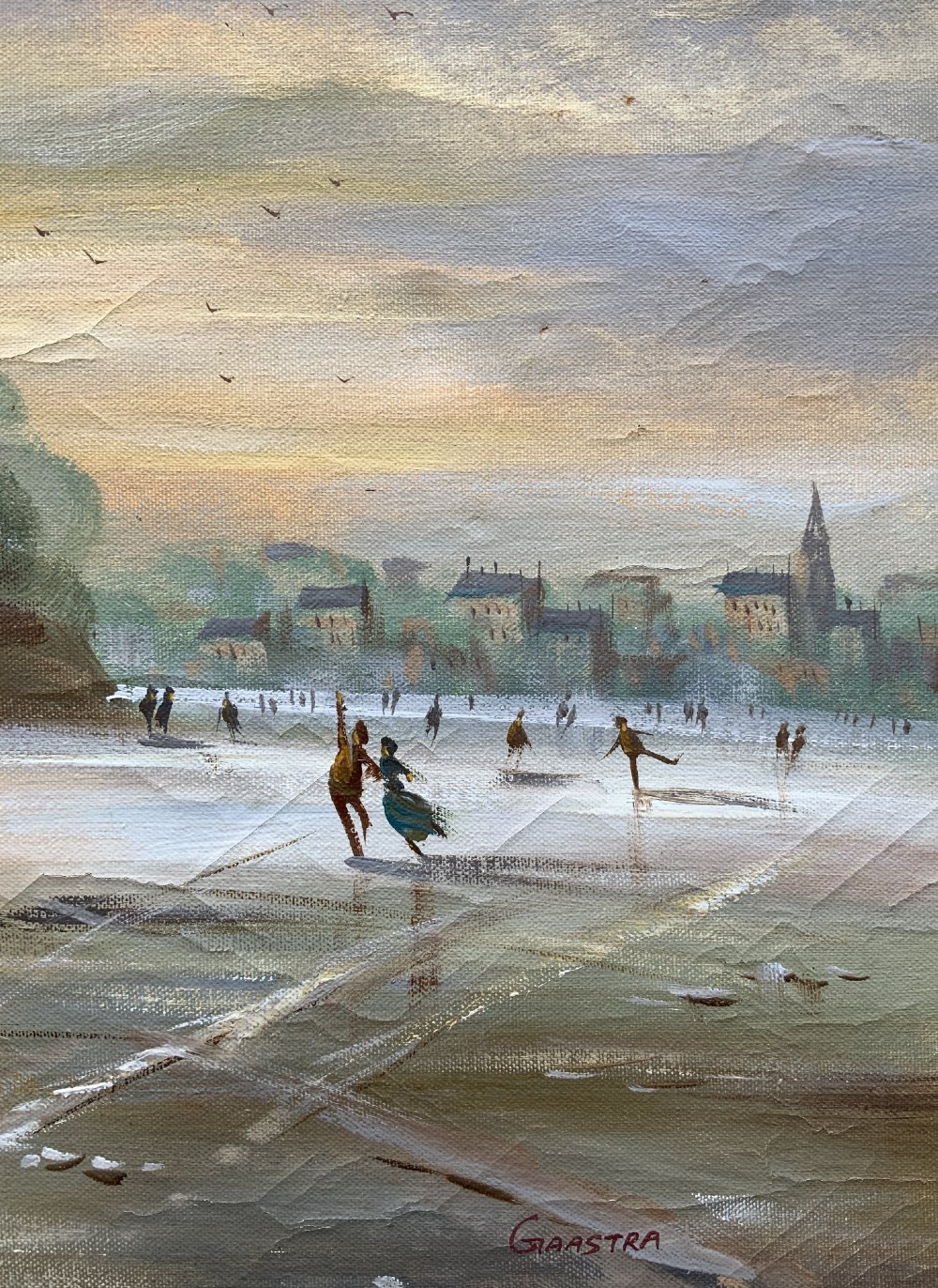 A large framed oil painting depicting figures ice skating on a frozen canal beside historic stone buildings under a winter sky, housed in an ornate gilt frame. View VII