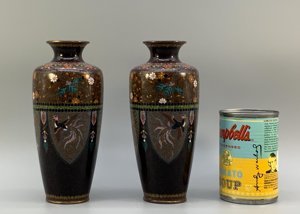 A pair of Japanese Meiji period cloisonne enamel vases featuring detailed phoenix birds, floral motifs, and geometric borders on a dark background. View III
