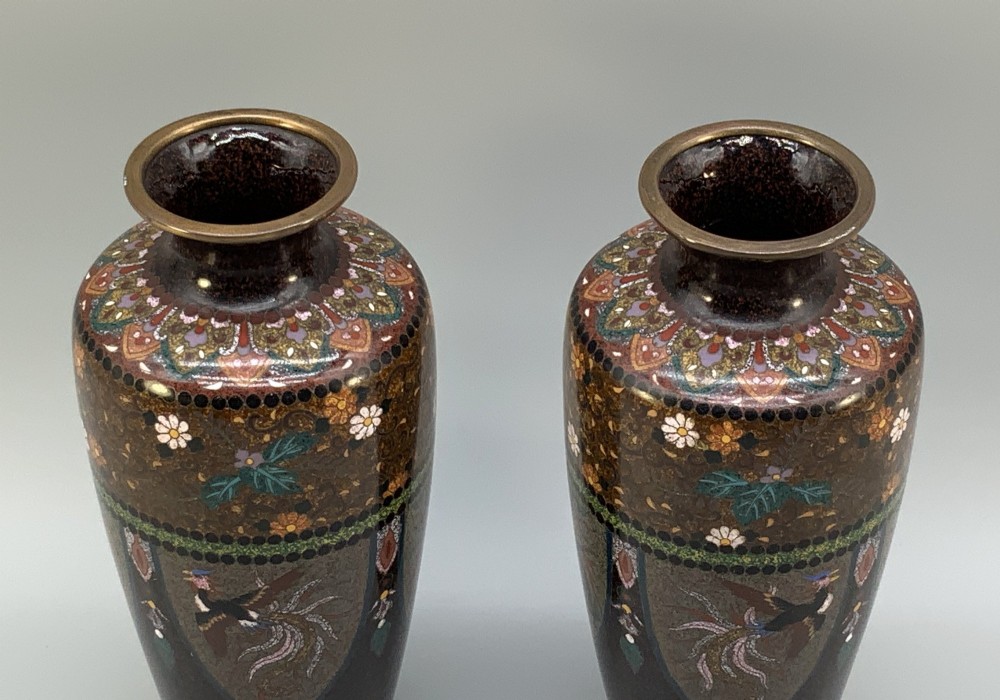 A pair of Japanese Meiji period cloisonne enamel vases featuring detailed phoenix birds, floral motifs, and geometric borders on a dark background. View VI