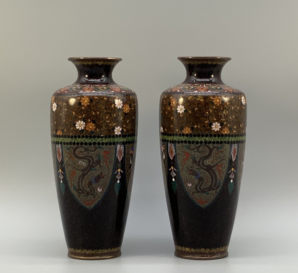 A pair of Japanese Meiji period cloisonne enamel vases featuring detailed phoenix birds, floral motifs, and geometric borders on a dark background. View VIII