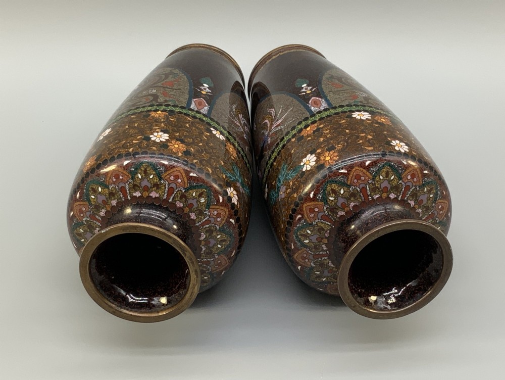 A pair of Japanese Meiji period cloisonne enamel vases featuring detailed phoenix birds, floral motifs, and geometric borders on a dark background. View IX