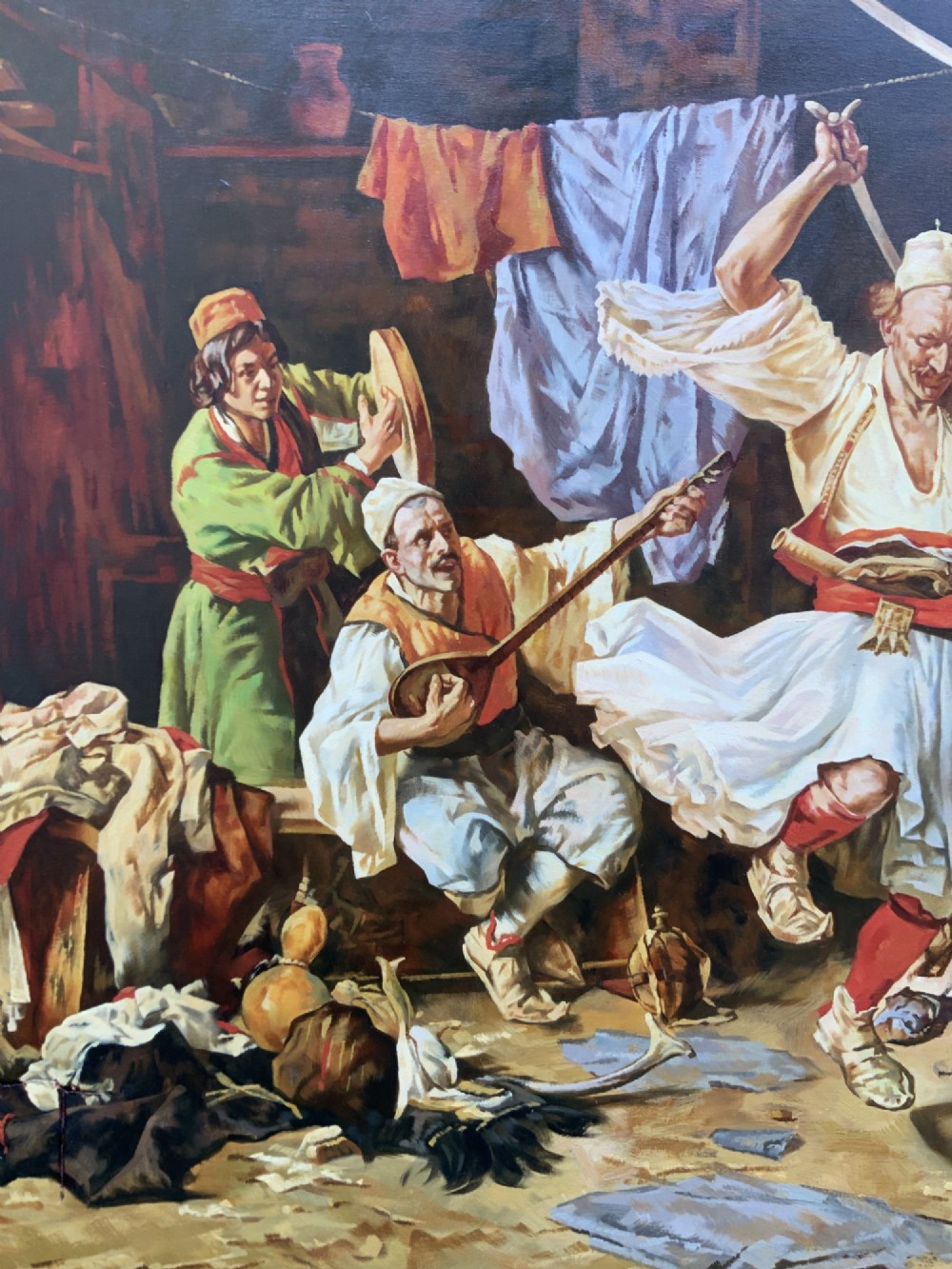A large mid-century framed oil painting depicting figures in traditional attire watching a man perform a sword dance inside a rustic interior. View VII