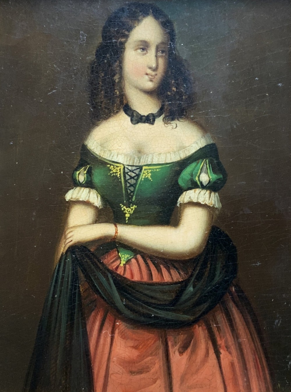 A framed miniature oil portrait depicting a Victorian woman with dark curly hair in a green and red dress, enclosed in a gilded wooden frame with egg-and-dart detail. View II