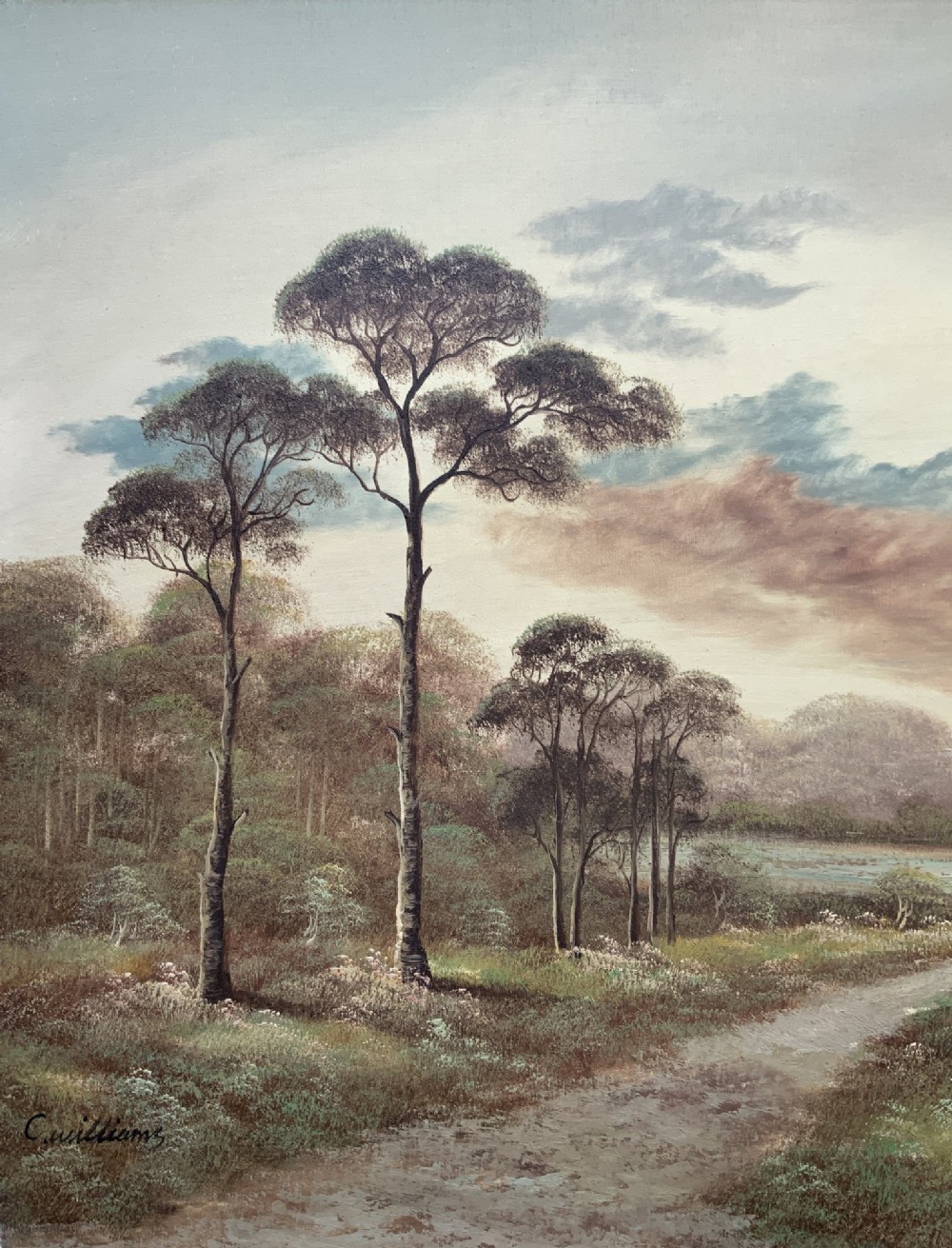 A twentieth-century framed oil painting depicting a countryside path alongside a reflective pond, surrounded by tall trees and distant hills under a clouded sky. View IV