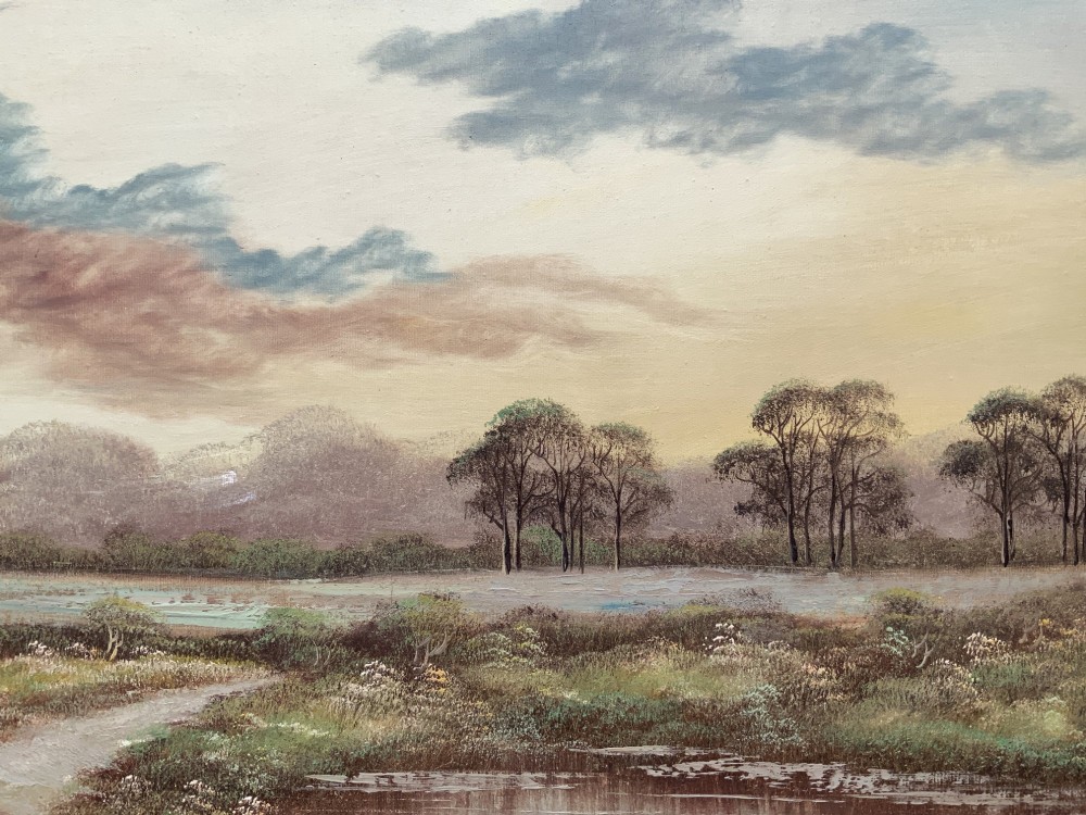 A twentieth-century framed oil painting depicting a countryside path alongside a reflective pond, surrounded by tall trees and distant hills under a clouded sky. View VIII