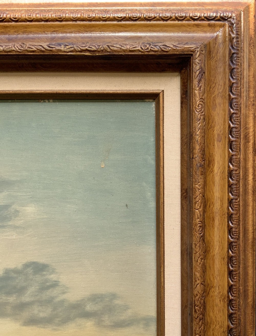 A twentieth-century framed oil painting depicting a countryside path alongside a reflective pond, surrounded by tall trees and distant hills under a clouded sky. View IX