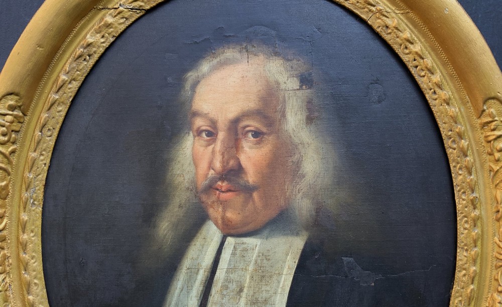An oval 17th-century oil painting depicting a gentleman with grey hair, a moustache, and white falling bands collar in a carved gold frame. View III