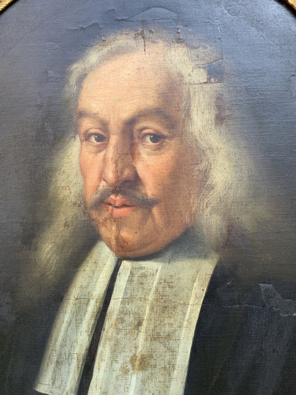 An oval 17th-century oil painting depicting a gentleman with grey hair, a moustache, and white falling bands collar in a carved gold frame. View IV