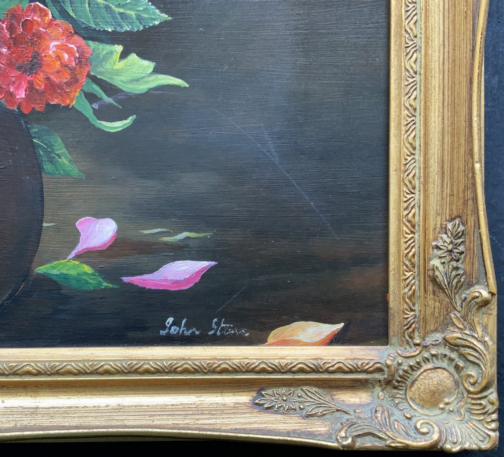 A framed mid-20th-century oil painting depicting a colourful floral arrangement in a brass vase against a dark background. View X
