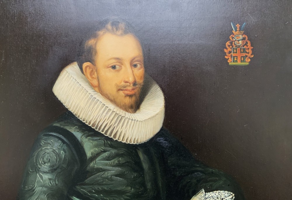 A full-length oil painting depicting a 17th-century gentleman in a dark doublet and white ruff collar, set within a black and gold frame. View IV