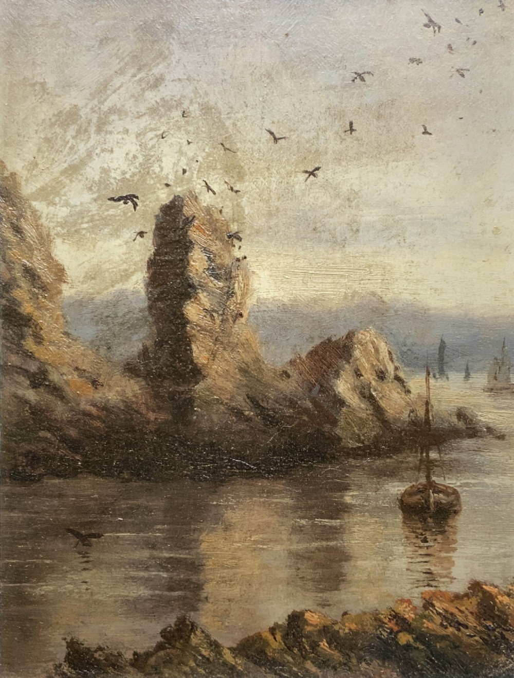 A 19th-century miniature oil painting depicting a coastal cliff scene with a prominent rock stack, small boats, and birds in flight, set within a dark wooden frame. View II