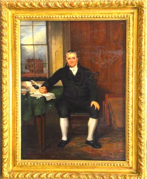 fig 1. A Georgian oil portrait depicting a seated gentleman in a dark coat holding a quill at a desk covered with green cloth, in front of a panelled wall and window.