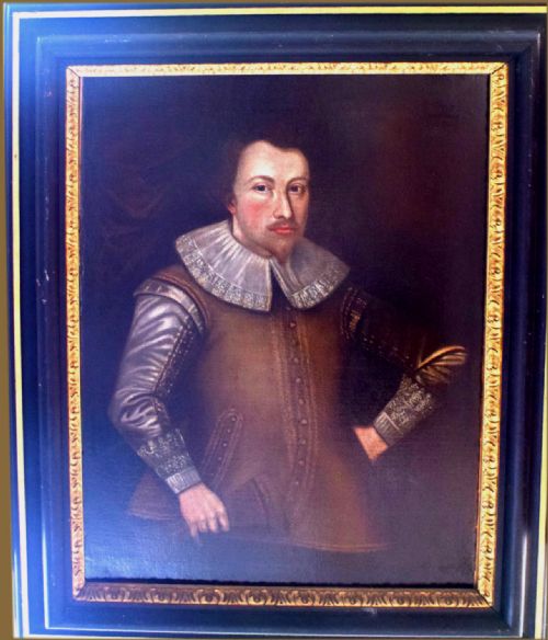 fig 3. An oil portrait on canvas depicting a Tudor gentleman wearing an embroidered brown doublet with a white lace collar and detailed cuffs.