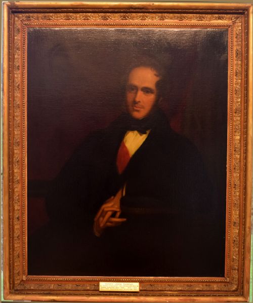 fig 6. A 19th-century oil painting depicting a gentleman in dark attire wearing a red sash and bow tie against a dark background.