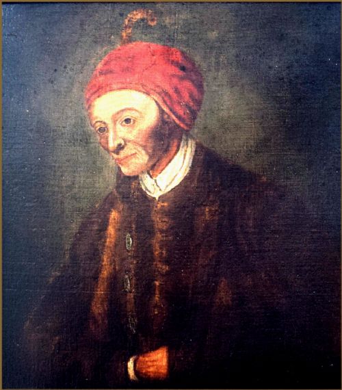 fig 2. An 18th-century oil painting depicting an elderly man wearing a red cap and dark coat against a dark background.