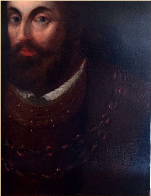 fig 2. An eighteenth-century oil painting on canvas depicting a bearded man in historical garments against a dark background with top inscribed lettering.
