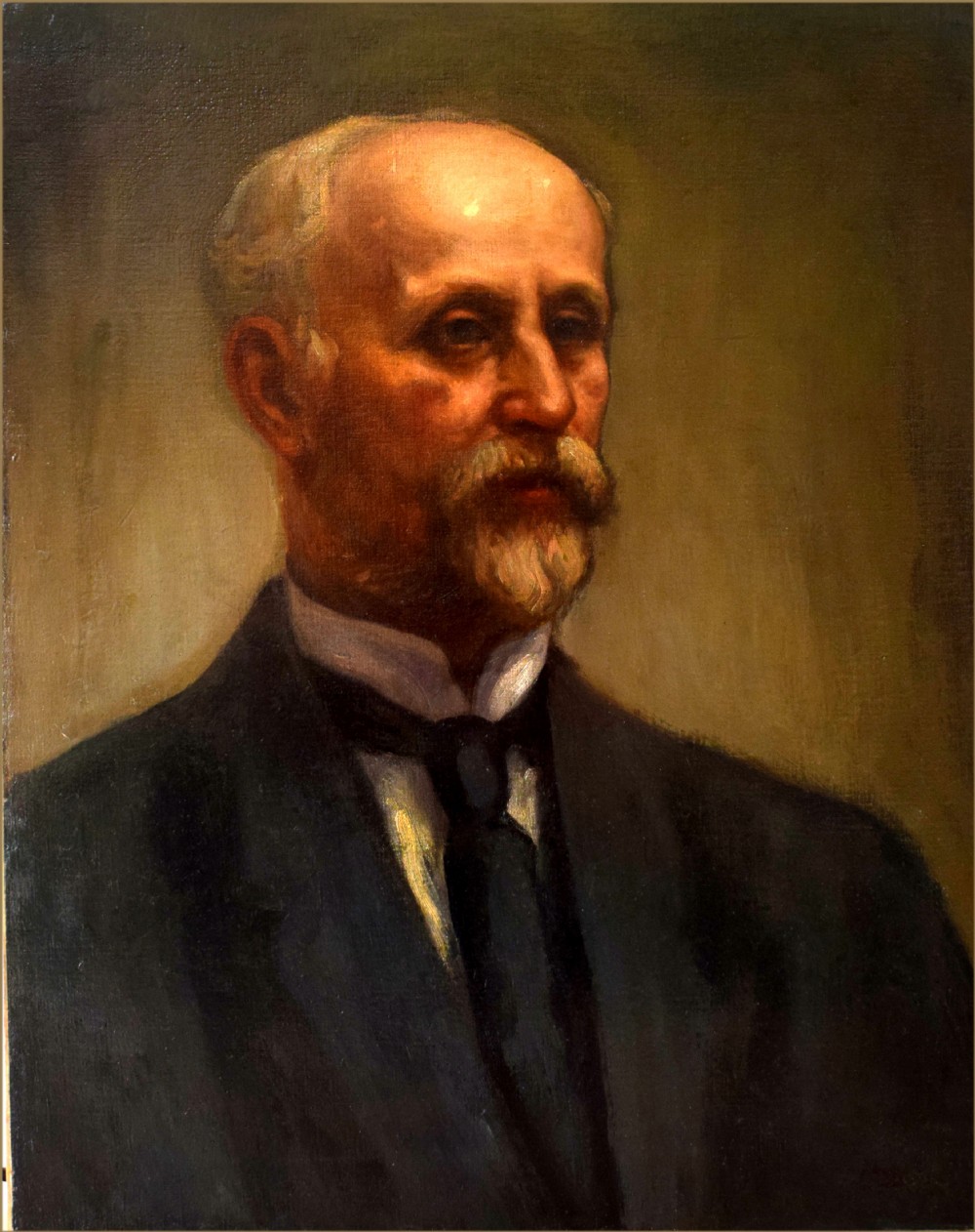 An oil painting on canvas depicting a gentleman with a grey moustache and beard wearing a dark formal suit jacket and tie.
