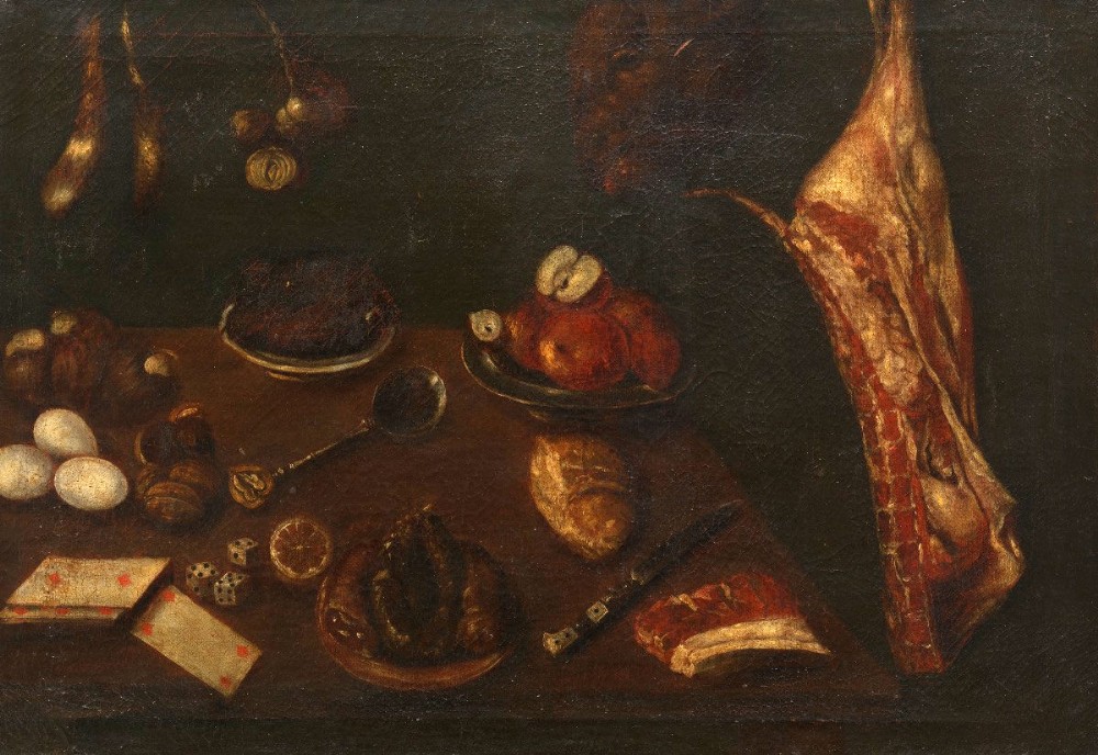 A 17th-century Spanish Baroque oil painting depicting a tabletop larder scene with meat, eggs, walnuts, bread, dice, playing cards, and utensils against a dark background.