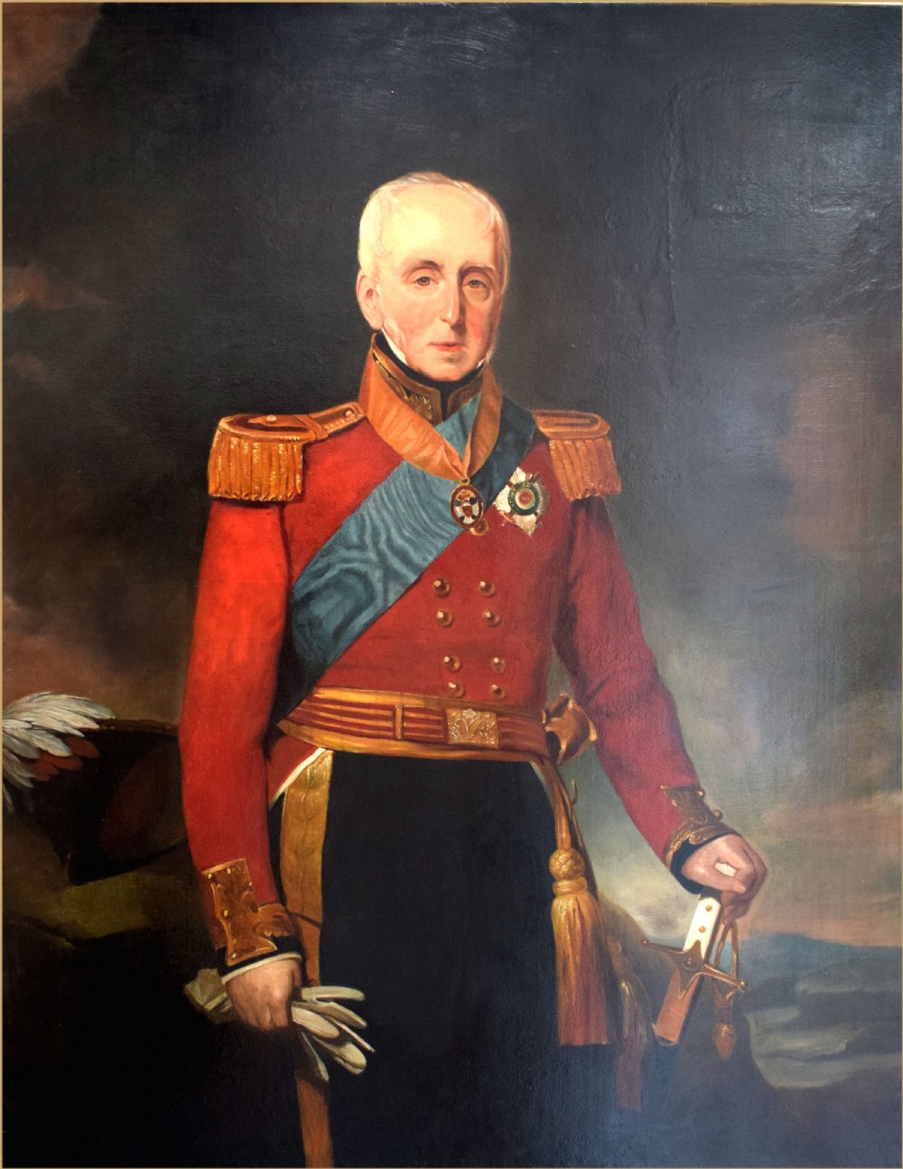 An early nineteenth-century oil portrait of a military officer standing in a scarlet coat with gold epaulettes, a blue sash, and military decorations.