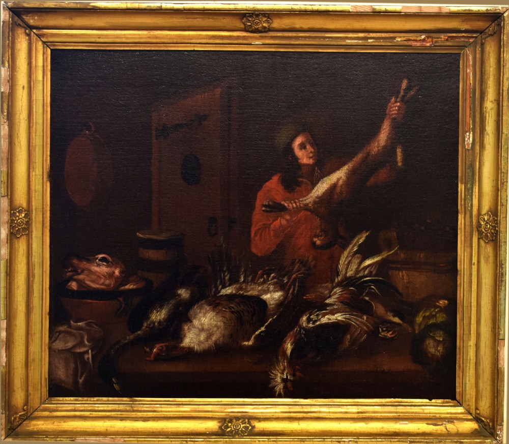 An 18th-century Dutch School oil painting depicting a figure in a red garment arranging game birds and an animal head inside a dark larder. View V