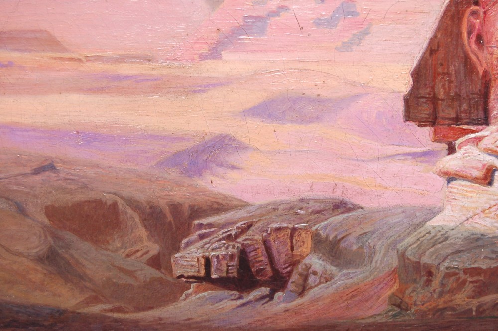 An Orientalist oil painting on canvas depicting the Sphinx and the Pyramids of Giza set against a muted pink sky with figures and camels in the foreground. View IV