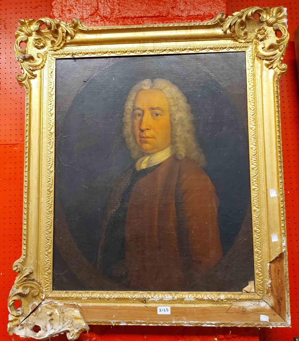 A mid-eighteenth-century oil painting depicting a gentleman with a powdered wig, white cravat, and brown coat set within a painted feigned oval frame. View V