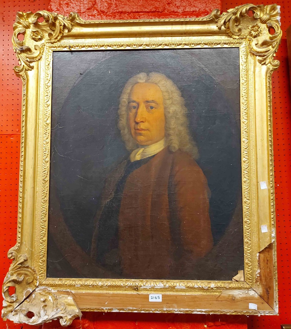A mid-eighteenth-century oil painting depicting a gentleman with a powdered wig, white cravat, and brown coat set within a painted feigned oval frame. View VI
