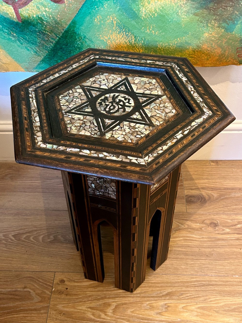 A hexagonal dark wood side table featuring intricate Mother-of-Pearl geometric inlays, a central calligraphic star motif, and arched cutout legs. View III