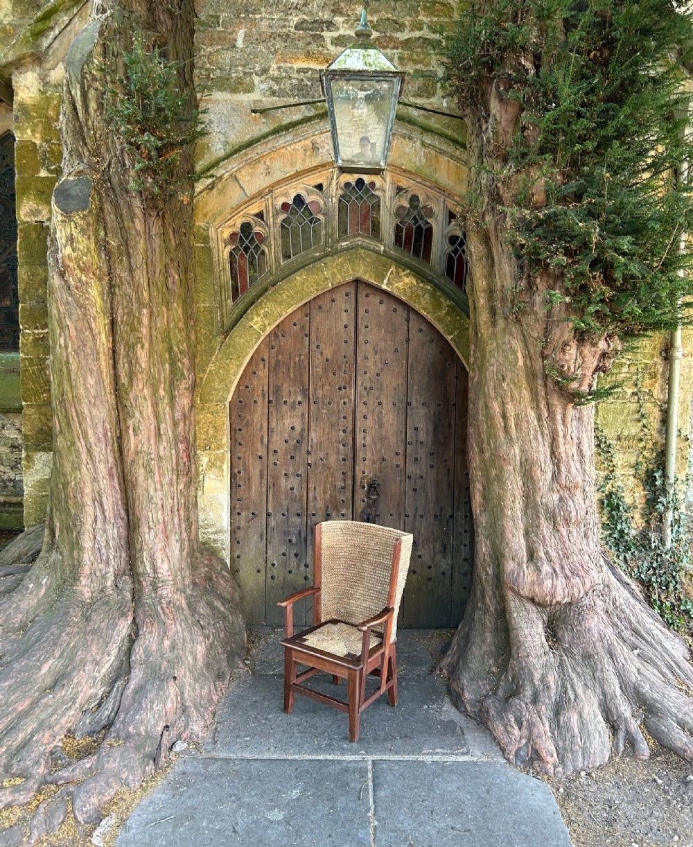 An antique Scottish Orkney armchair featuring a dark oak wood frame, scrolled arms, a drop-in rush seat, and a tall woven straw backrest. View IX
