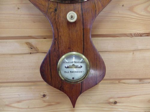 fig 1. A Victorian wall-mounted mahogany banjo mercury barometer featuring a silvered dial, spirit thermometer, convex mirror, and brass fittings.
