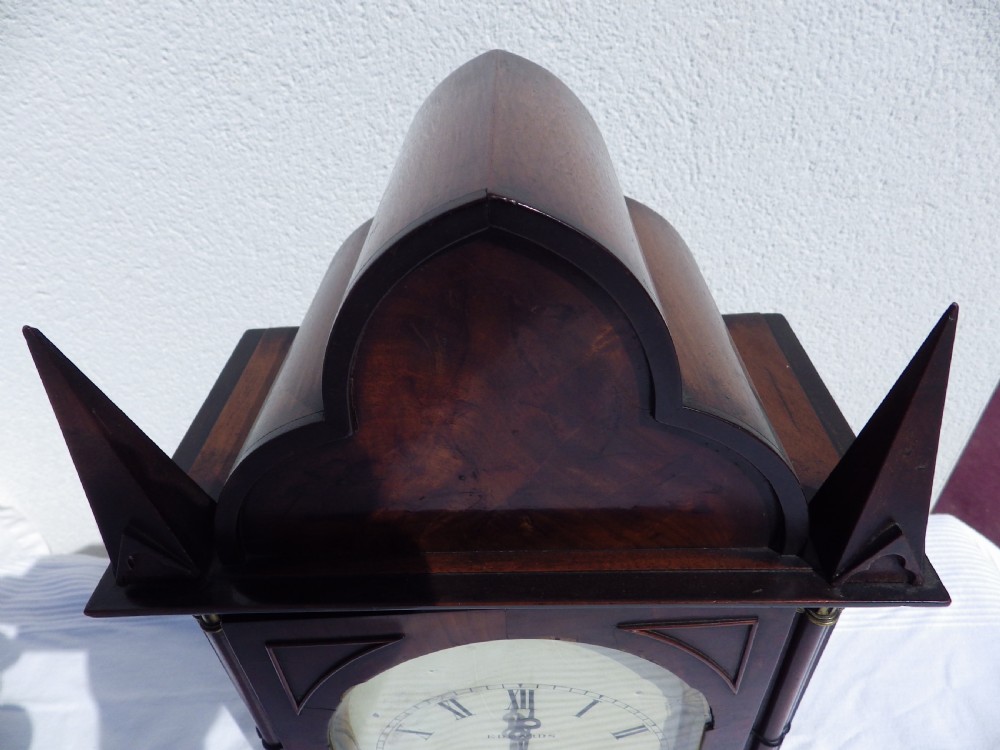A Victorian Gothic Revival mahogany double fusee bracket clock featuring spire finials, reeded side columns, and an arched cream dial face with Roman numerals. View II