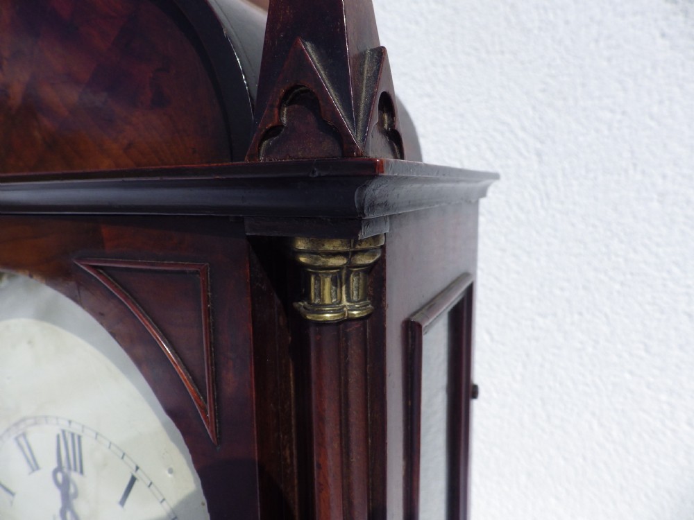 A Victorian Gothic Revival mahogany double fusee bracket clock featuring spire finials, reeded side columns, and an arched cream dial face with Roman numerals. View IV
