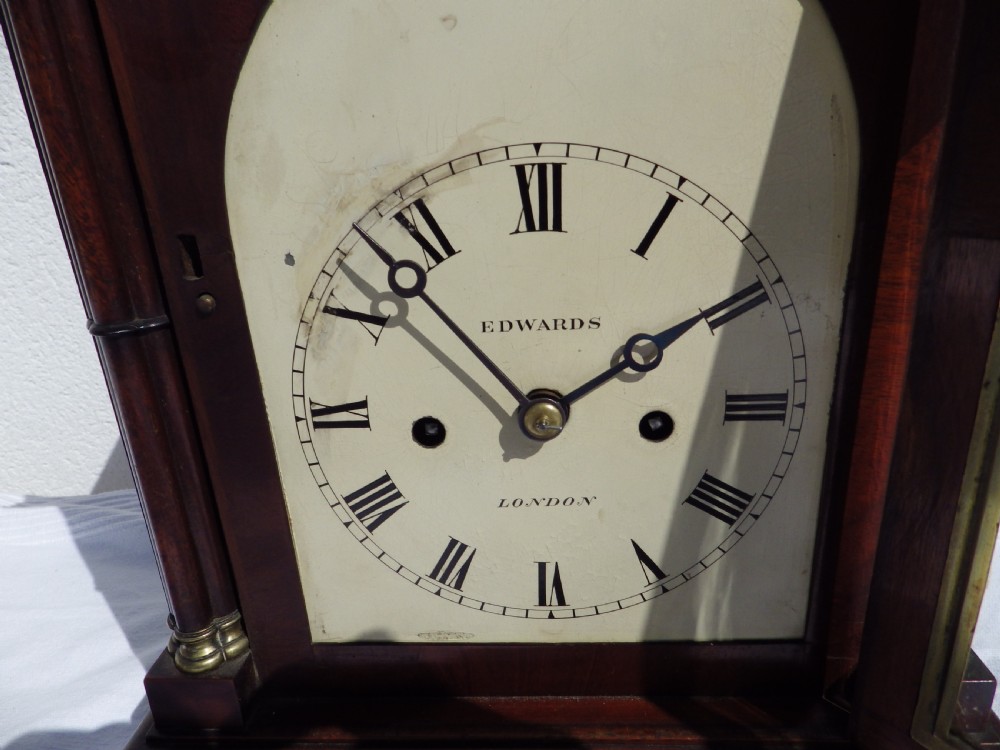 A Victorian Gothic Revival mahogany double fusee bracket clock featuring spire finials, reeded side columns, and an arched cream dial face with Roman numerals. View V