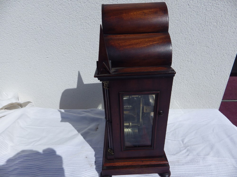 A Victorian Gothic Revival mahogany double fusee bracket clock featuring spire finials, reeded side columns, and an arched cream dial face with Roman numerals. View VI