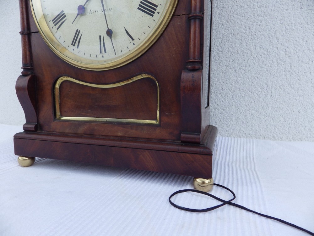 A carved mahogany English double fusee bracket clock featuring a circular cream dial with Roman numerals signed Osborn Bognor. View III