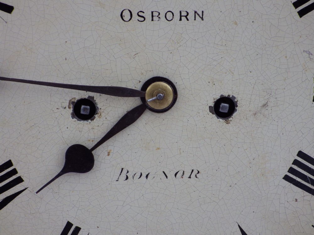 A carved mahogany English double fusee bracket clock featuring a circular cream dial with Roman numerals signed Osborn Bognor. View IX