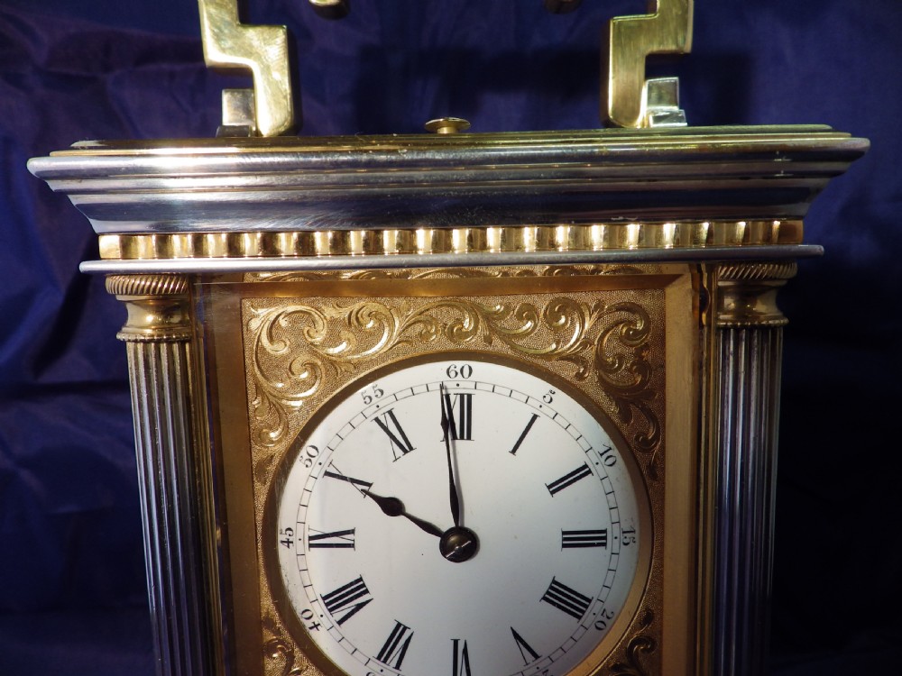 A nineteenth-century gilded brass French carriage clock featuring fluted corner columns, foliate engraving, a white enamel dial with Roman numerals, and a hinged carrying handle. View III