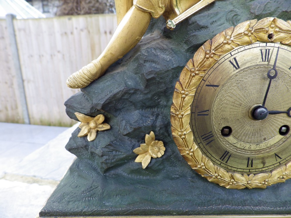 An antique French Empire gilt and patinated bronze mantel clock featuring sculpted figures of medieval soldiers above an ornamented base. View VII