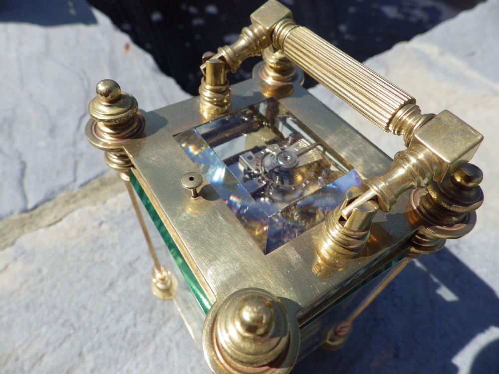 A nineteenth-century French gilt brass carriage clock decorated with polychrome champleve enamel panels and a white dial with Arabic numerals. View VII