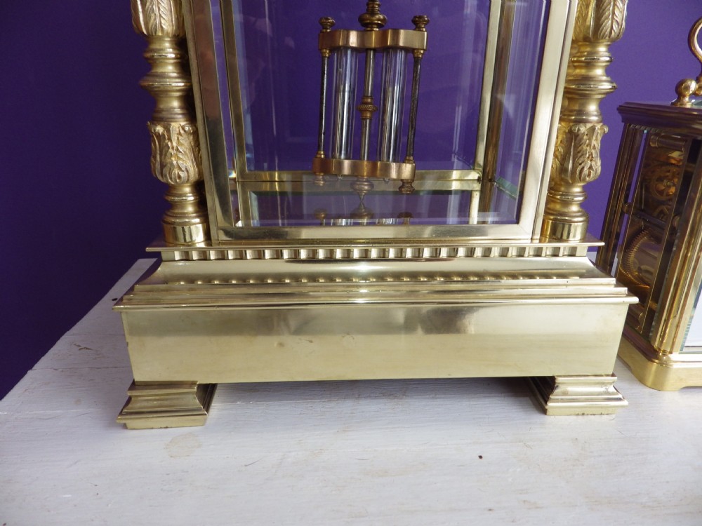 A nineteenth-century French gilt brass crystal regulator mantel clock featuring four bevelled glass sides, fluted corner columns, an enamel dial with Roman numerals, and a visible pendulum. View II