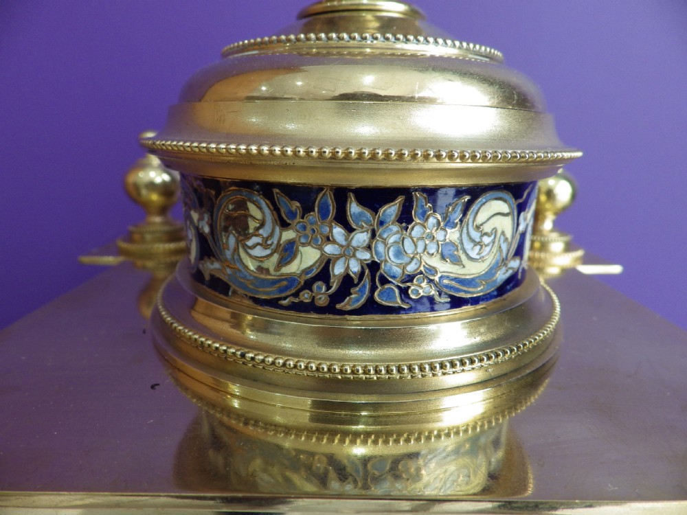 An antique French gilt brass crystal regulator clock featuring four clear glass sides, blue champleve enamel scrollwork, decorative corner columns, and an intricate dial. View VIII