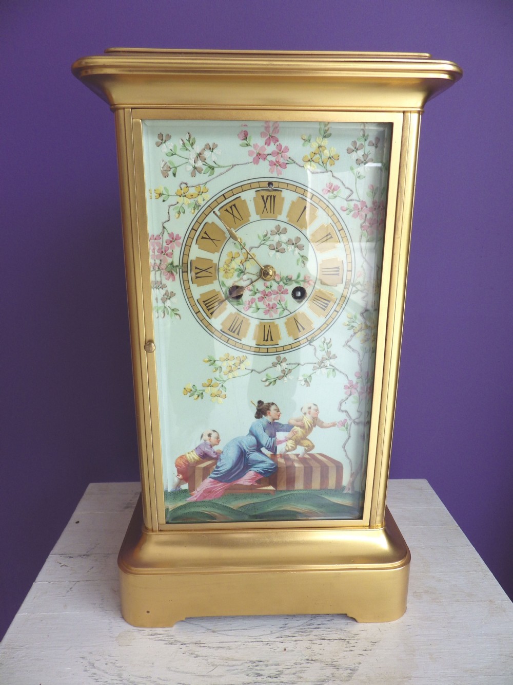 A late 19th-century French gilt brass crystal regulator clock featuring a hand-painted enamel front panel decorated with Chinoiserie figures and floral motifs.