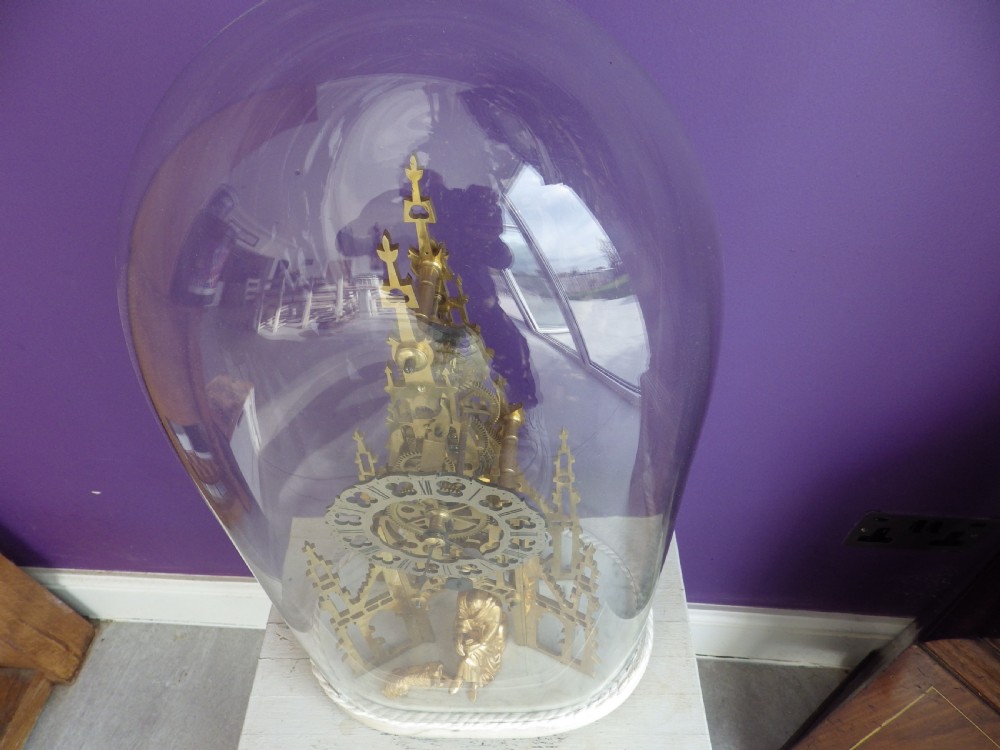 Victorian brass skeleton clock modelled after the Scott Monument featuring an openwork frame, silvered chapter ring, seated figurine, and white marble base. View VII