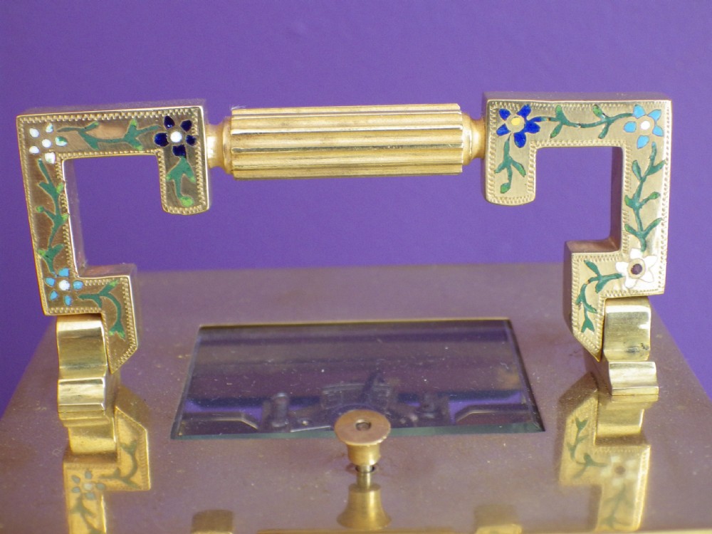 Late nineteenth-century gilt brass French carriage clock featuring polychrome floral enamel borders, a carrying handle, and an enamel dial with Arabic numerals. View III