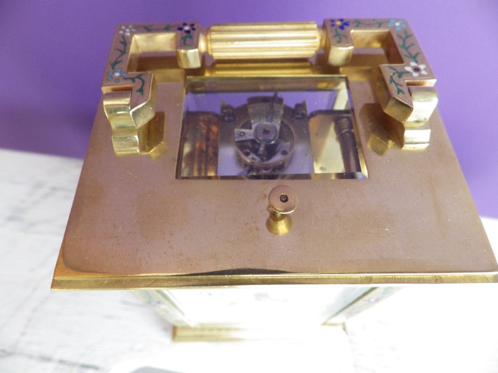 Late nineteenth-century gilt brass French carriage clock featuring polychrome floral enamel borders, a carrying handle, and an enamel dial with Arabic numerals. View VIII
