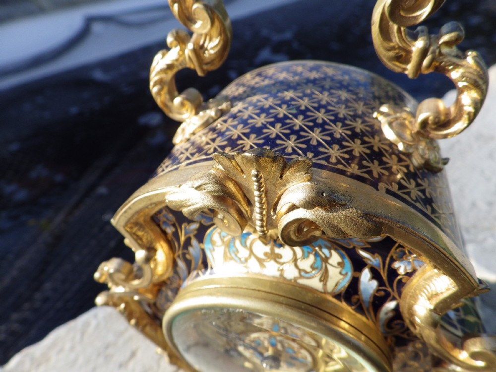 A late 19th-century French Rococo revival mantel clock crafted in gilt bronze ormolu with blue and cream champleve enamel detailing. View III