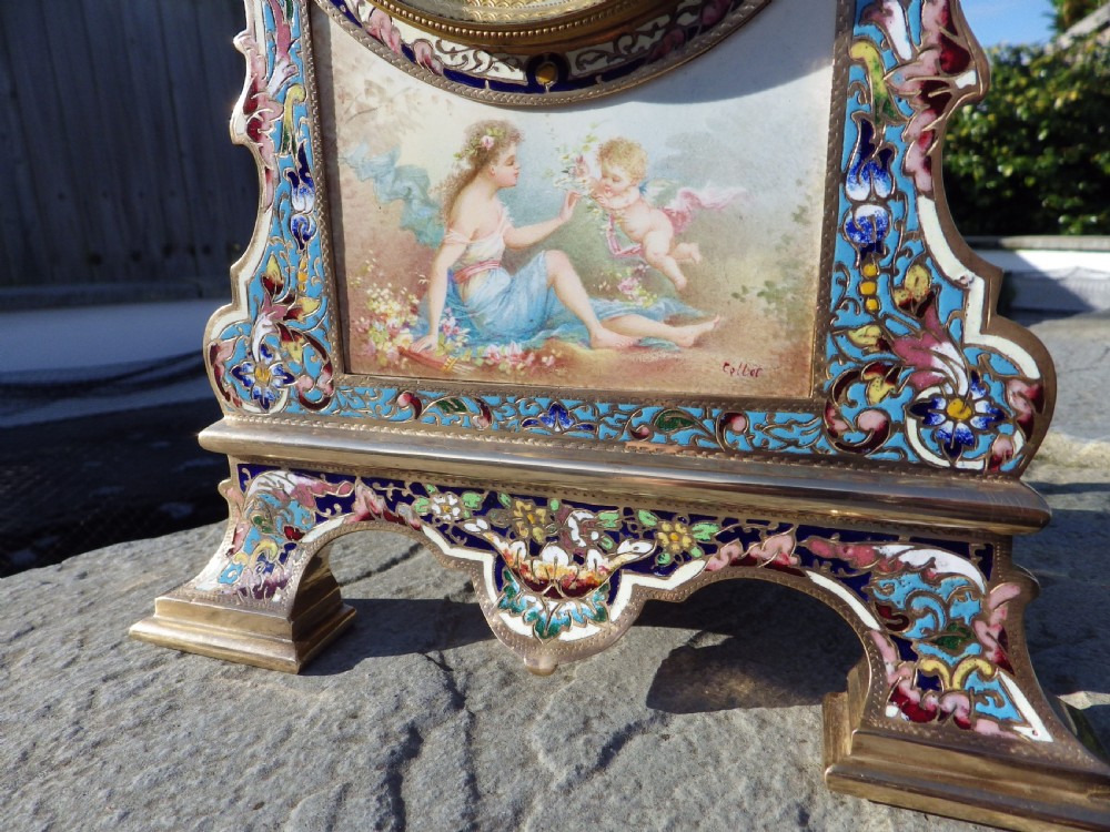 A French gilt brass mantel clock featuring intricate polychrome champleve enamel ornamentation and a hand-painted enamel panel depicting a classical figure and child. View II
