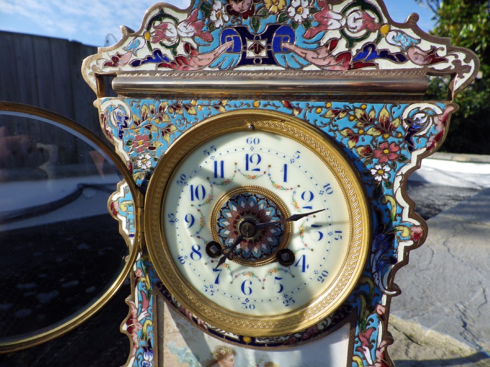 A French gilt brass mantel clock featuring intricate polychrome champleve enamel ornamentation and a hand-painted enamel panel depicting a classical figure and child. View III