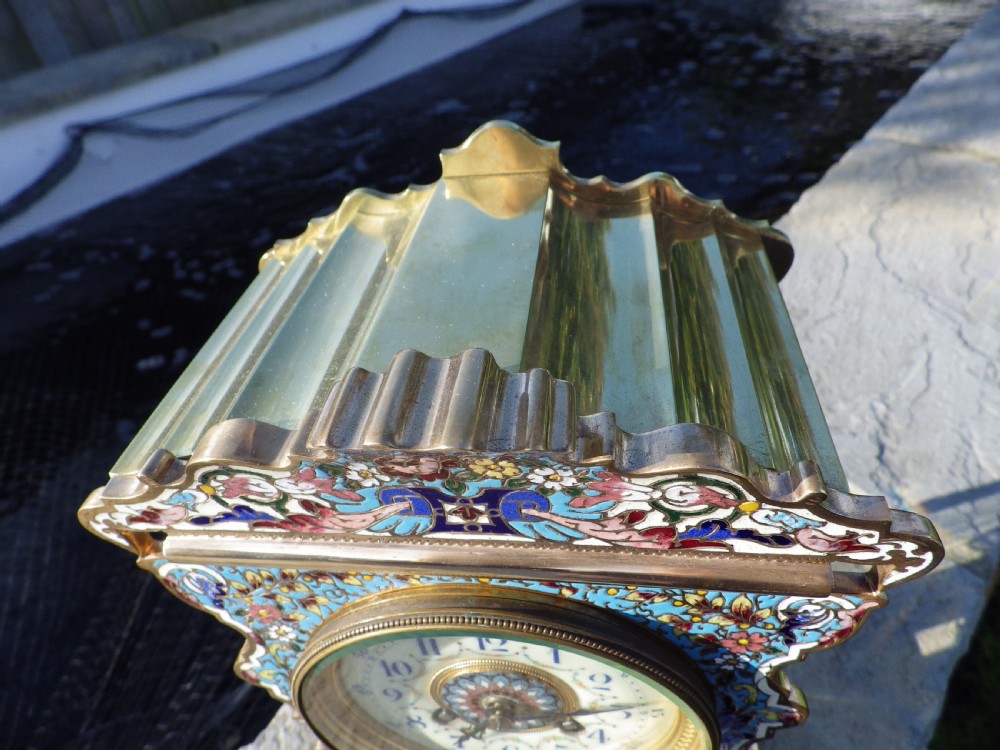 A French gilt brass mantel clock featuring intricate polychrome champleve enamel ornamentation and a hand-painted enamel panel depicting a classical figure and child. View IV